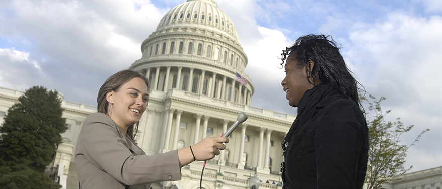 Student conducts interview in front of Capital building